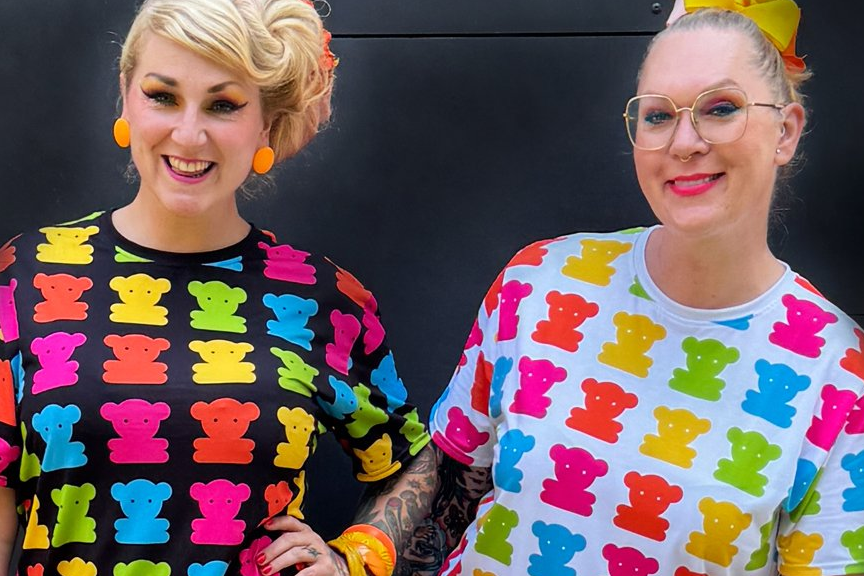 Two women in colorful t-shirt dresses with a sweet teddy print.