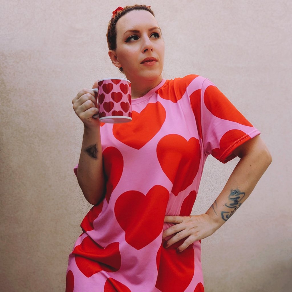 A woman wearing a colorful t-shirt dress by SHALMIAK. Design: ELLIE LOVE red.