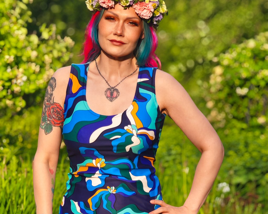 Woman wearing a colorful tank top by SHALMIAK. Design: SASSY IRIS purple.