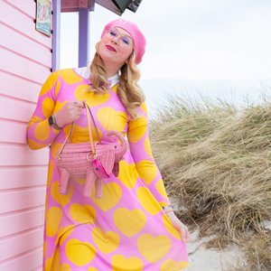 Woman in a colorful midi dress by SHALMIAK. Design: ELLIE LOVE yellow pink.